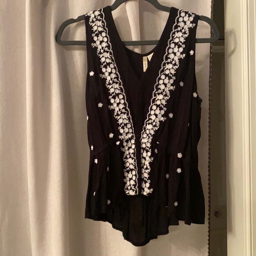 Black top with white floral embroidery